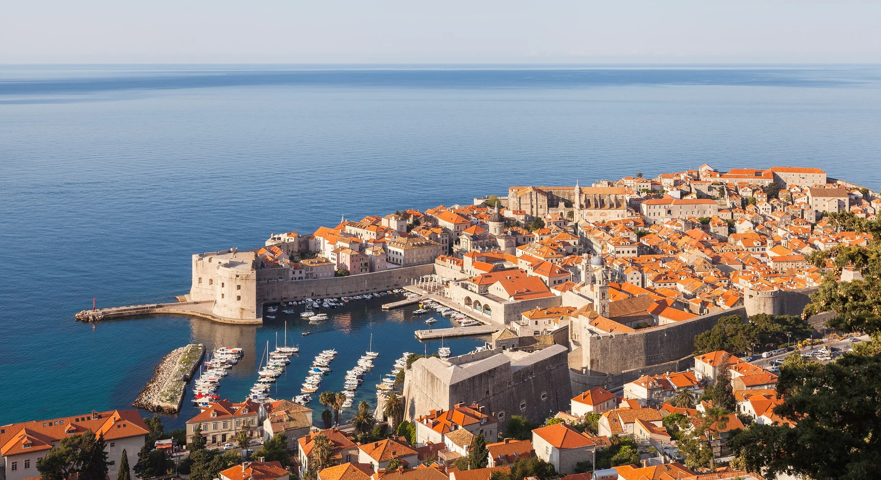 Golden morning light over Dubrovnik Old Town and its harbour
